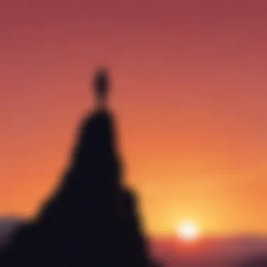 Silhouette of a person standing on a mountaintop at sunset